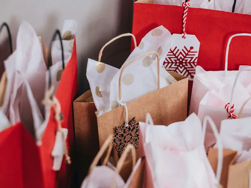 Paper shopping bags with tissue paper and gift tags